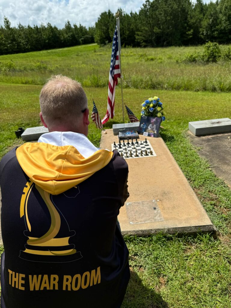 Todd Andrews at the gravesite of Emory Tate.