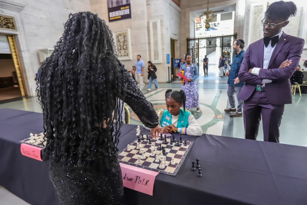 Special guest Jessica Hyatt plays against Windsor Polk while Jackson looks on.
Photo by Kimberly P. Mitchell/Detroit Free Press