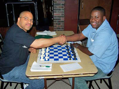 Eddie Mark III (right) shake hands with Douglas DuBose prior to the final round of the Buffalo City Championship. The game was quickly drawn giving Mark the title. Photo from buffalochess.blogspot.com.