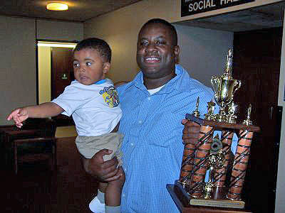 Eddie Mark III (right) celebrating with his son Eddie IV. Photo from buffalochess.blogspot.com.