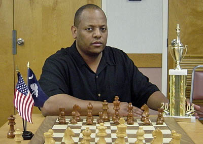 Keith Eubanks posing with the 2004 State Champion trophy. He shared the top honors with John Curcuru. Photo from scchess.org.