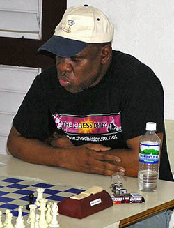 Jamaican Chess Federation President Ian Wilkinson dispatching of rising junior Hakim Buchanan.