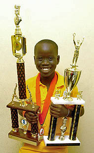 Tewana Mellace showing off his trophies from the 2007 Miami Orange Bowl. Photo by Jamaica Chess Federation.