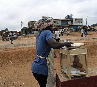 Woman selling the Ghanaian version of fried dough or 