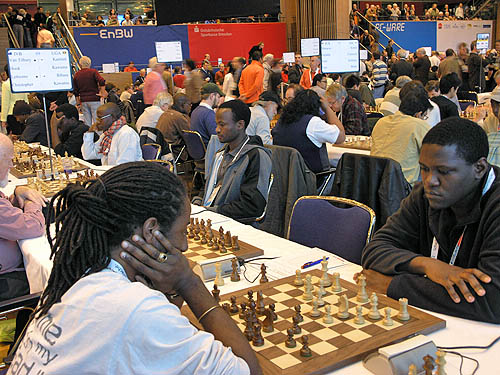Moses Kawuma (near right) playing against British Virgin Island’s Christopher Art. Kawuma scored 9/10 for the highest winning percentage in the open section. Steven Kawuma plays the legendary Bill Hook. Photo by Daaim Shabazz.